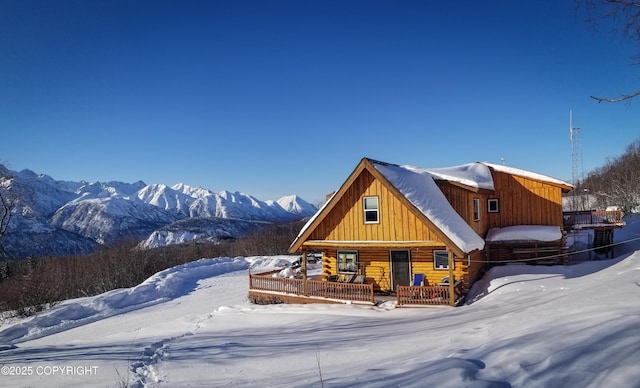 log-style house featuring a mountain view and covered porch