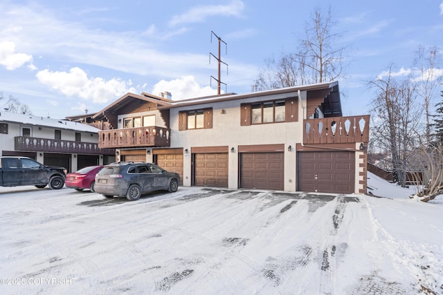 view of front of property featuring a balcony and a garage