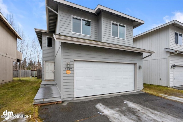 view of front of home featuring a garage and a front lawn