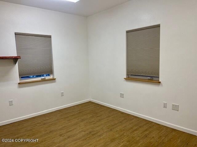 unfurnished room featuring dark wood-type flooring