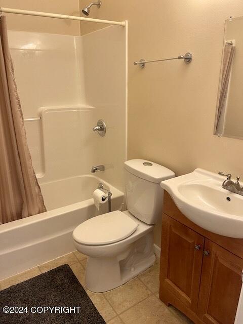 full bathroom featuring tile patterned floors, toilet, vanity, and shower / bath combo with shower curtain