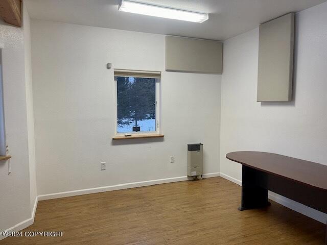 unfurnished office with hardwood / wood-style flooring