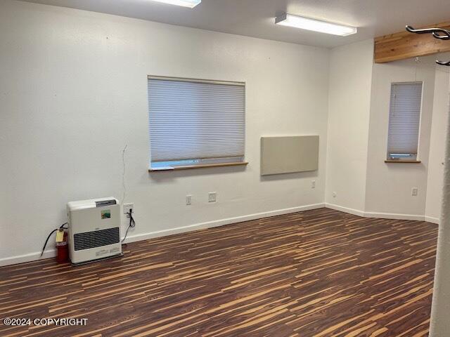 spare room featuring dark hardwood / wood-style floors