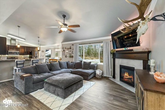 living room featuring ornamental molding, lofted ceiling, ceiling fan, and dark hardwood / wood-style flooring