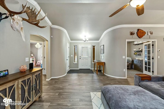 entrance foyer with crown molding, ceiling fan, and dark hardwood / wood-style flooring