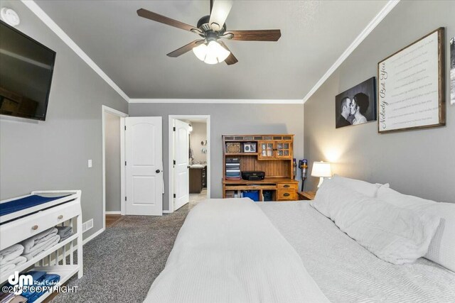 carpeted bedroom featuring crown molding, ceiling fan, and ensuite bathroom