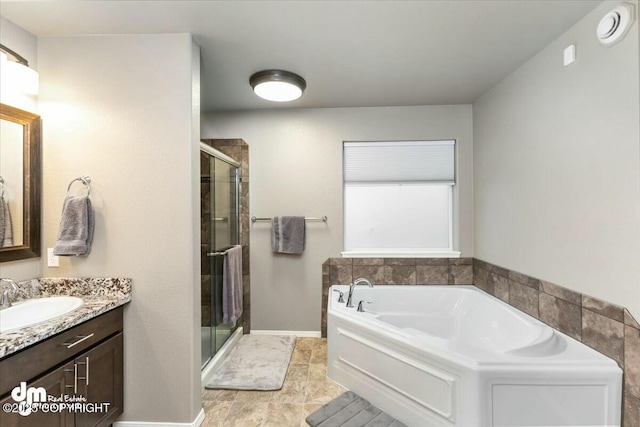 bathroom featuring vanity and separate shower and tub