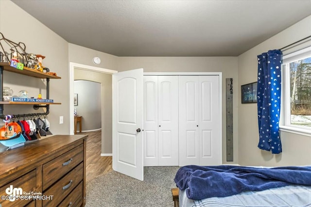 bedroom with hardwood / wood-style flooring and a closet