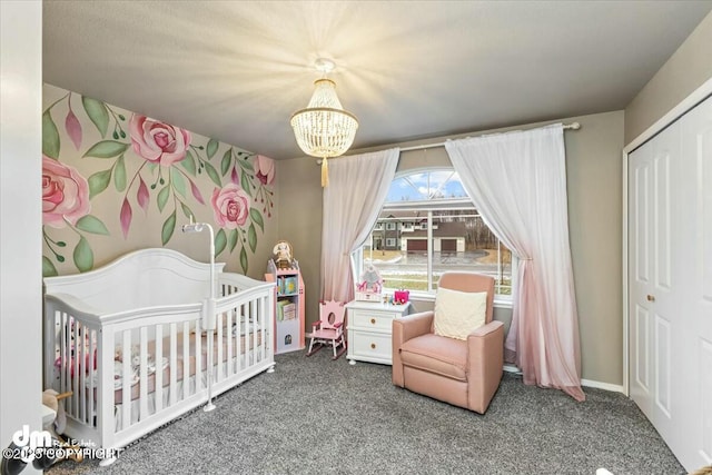 carpeted bedroom with a closet, a nursery area, and a chandelier