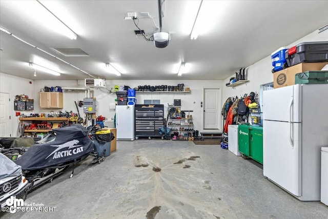 garage with a garage door opener, a workshop area, and white refrigerator