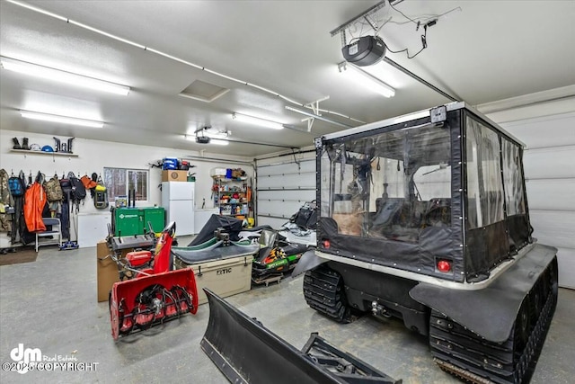 garage with a garage door opener and white refrigerator