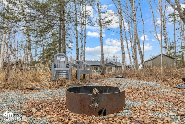 view of yard with an outdoor fire pit