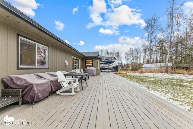 snow covered deck featuring a grill