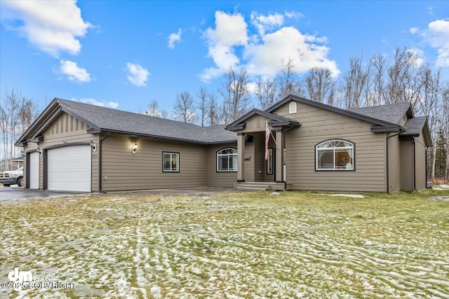 ranch-style home with a garage and a front lawn