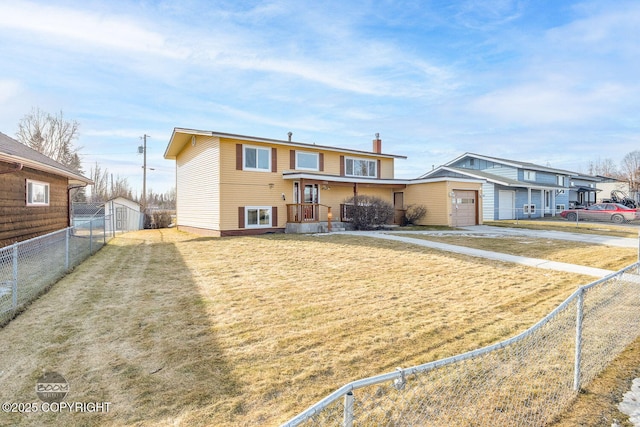 view of front of home with a garage, a front yard, and fence