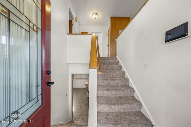 stairs with baseboards and carpet floors