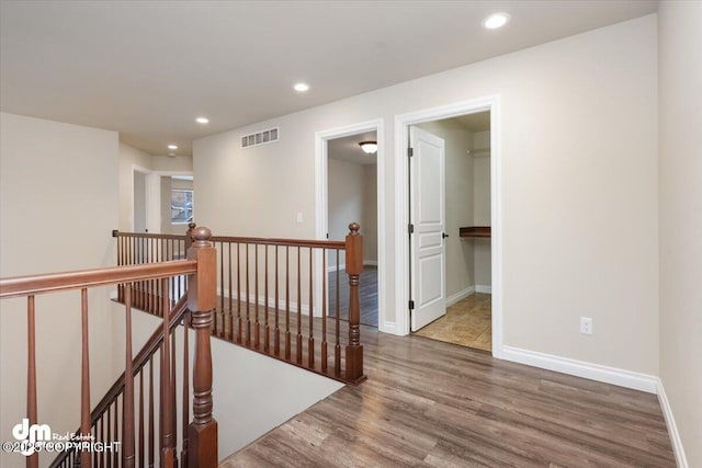 corridor with hardwood / wood-style floors