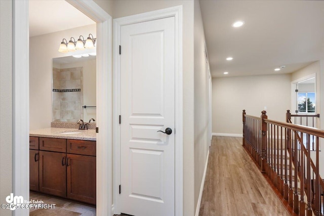 hall with sink and light hardwood / wood-style floors