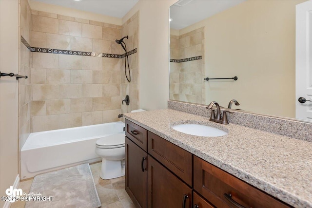 full bathroom with tiled shower / bath combo, vanity, and toilet