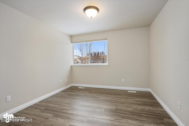 unfurnished room featuring dark hardwood / wood-style floors