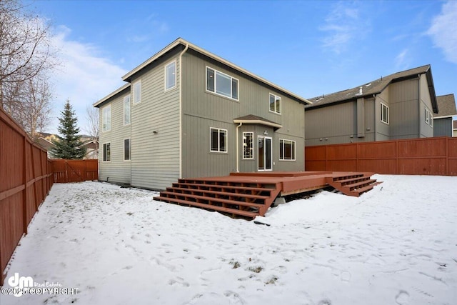 snow covered property featuring a wooden deck