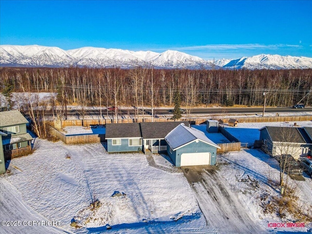 snowy aerial view featuring a mountain view