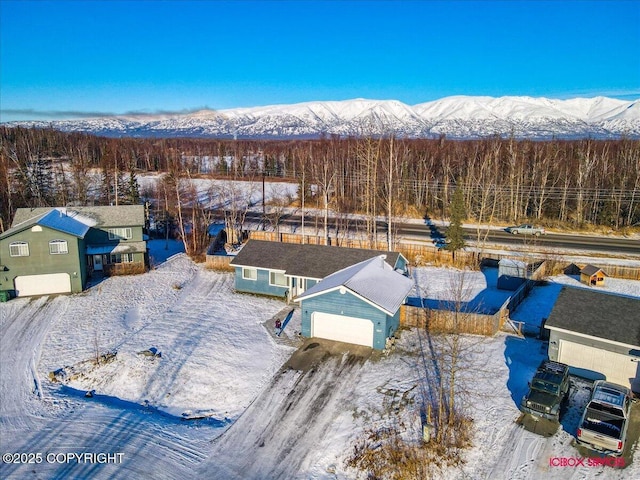 snowy aerial view featuring a mountain view