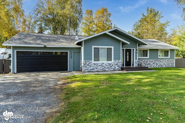 ranch-style house featuring a front yard and a garage