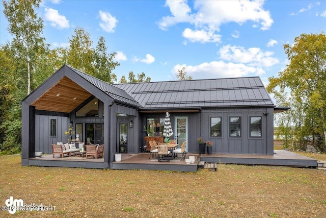 back of house with a yard, an outdoor hangout area, and a deck