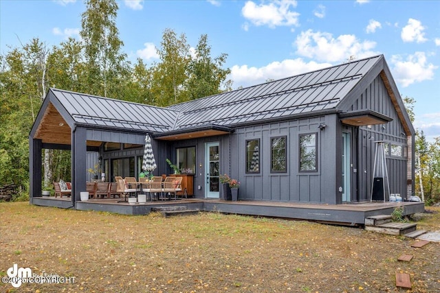 rear view of house featuring outdoor lounge area and a lawn