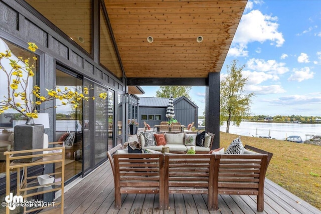 wooden terrace with an outdoor living space and a water view