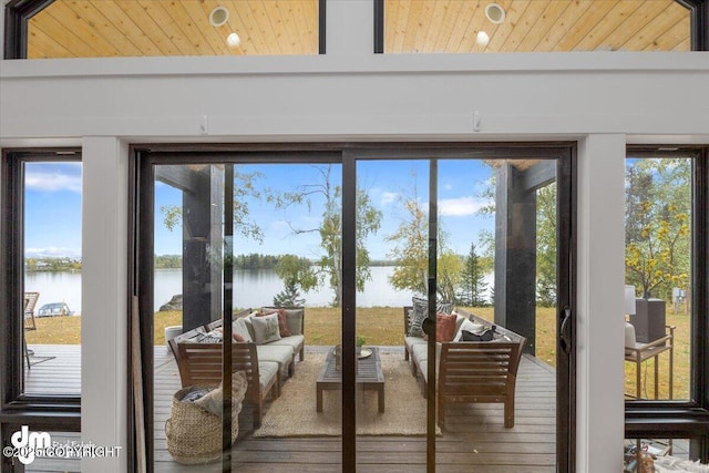 doorway with a water view and wood ceiling