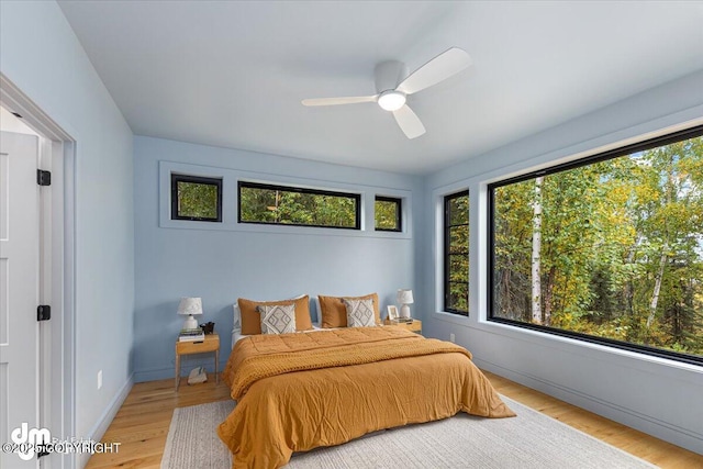 bedroom with ceiling fan and light hardwood / wood-style flooring