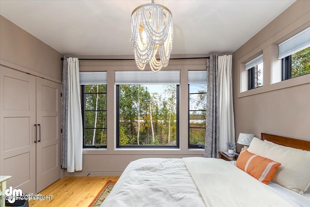 bedroom featuring a notable chandelier and light hardwood / wood-style floors