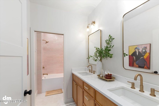 bathroom with vanity and tiled shower / bath combo