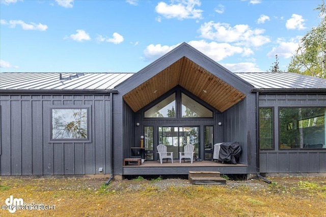 rear view of property featuring a wooden deck