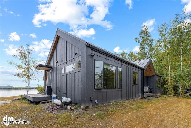 view of side of home with a water view