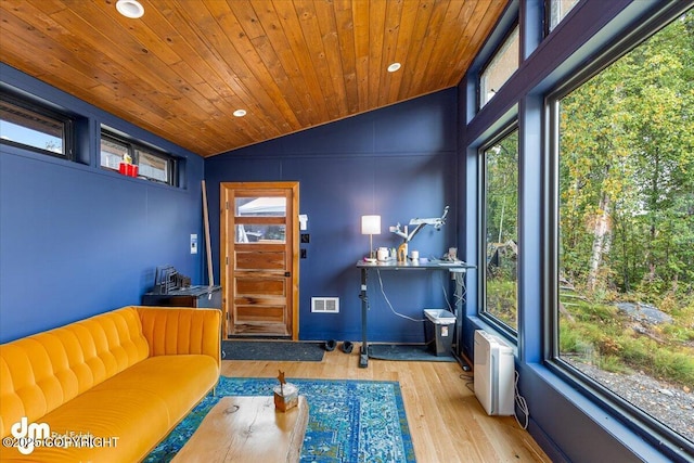 unfurnished room featuring lofted ceiling, light hardwood / wood-style flooring, wooden ceiling, and a healthy amount of sunlight