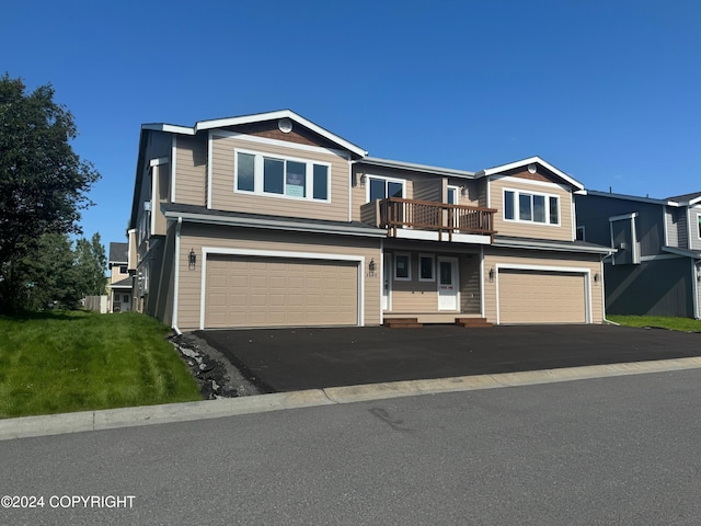 view of front of home with a garage and a front lawn