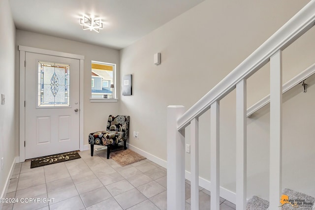 foyer entrance with light tile patterned floors