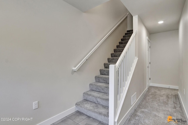 stairs featuring tile patterned flooring