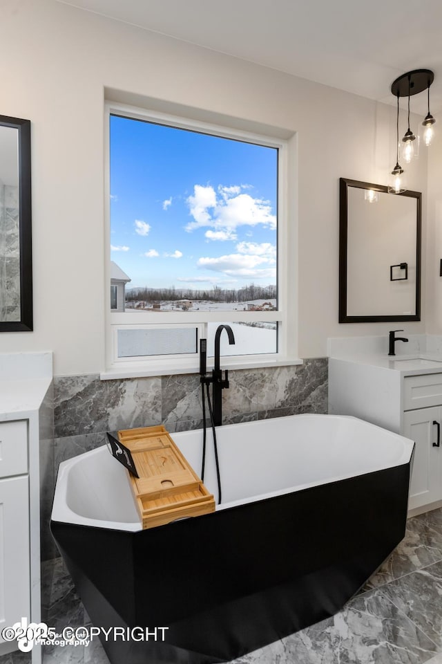 bathroom with vanity and a tub to relax in