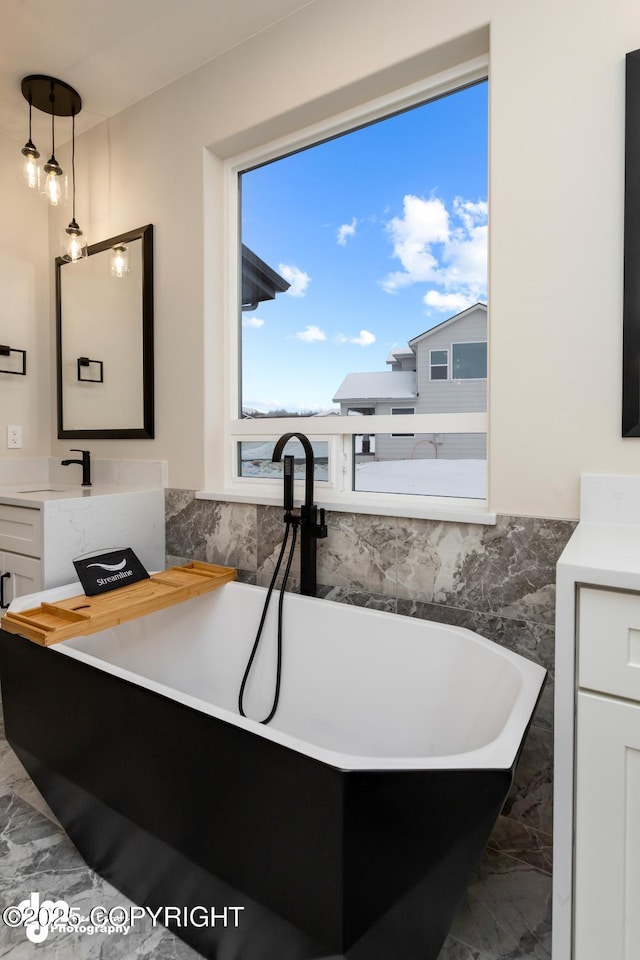 bathroom with vanity and a bathtub