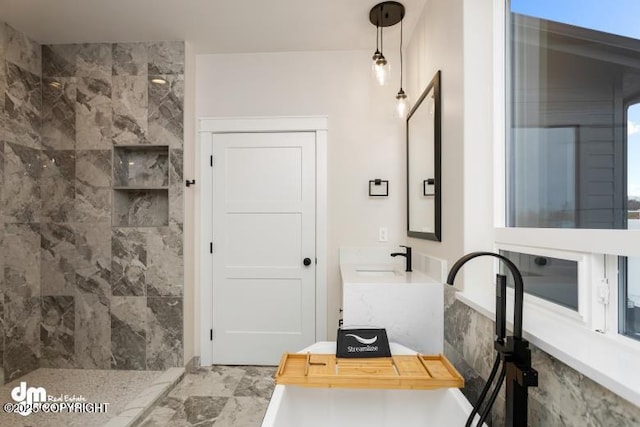 bathroom with vanity and tiled shower