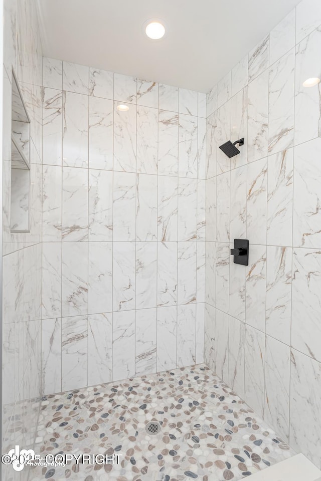 bathroom with a tile shower