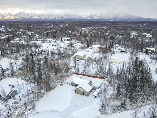 snowy aerial view with a mountain view