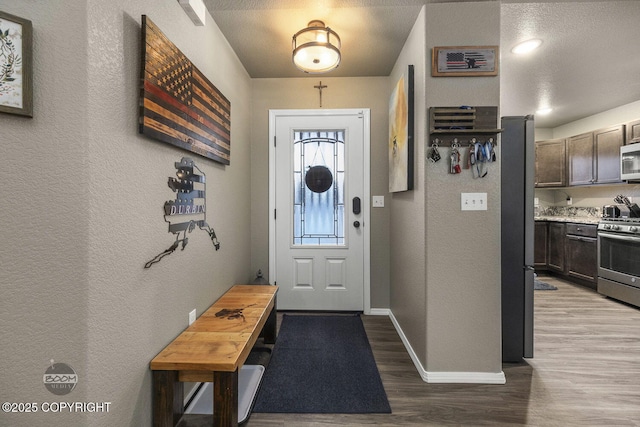 foyer entrance with light hardwood / wood-style floors