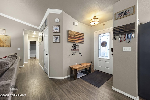 entryway with lofted ceiling, ornamental molding, dark hardwood / wood-style flooring, and a textured ceiling