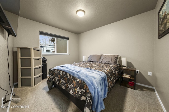 bedroom featuring carpet floors and a textured ceiling