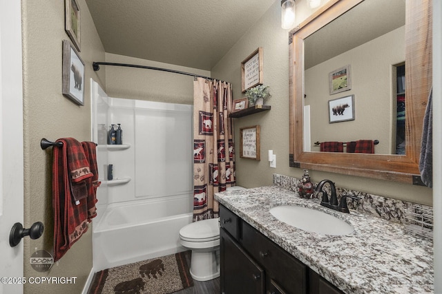 full bathroom with shower / bath combination with curtain, vanity, toilet, and a textured ceiling